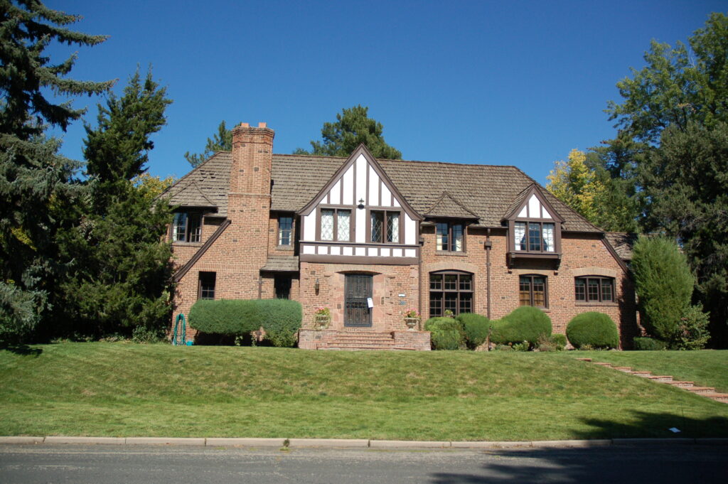 Large brick house with greenery Denver painting company