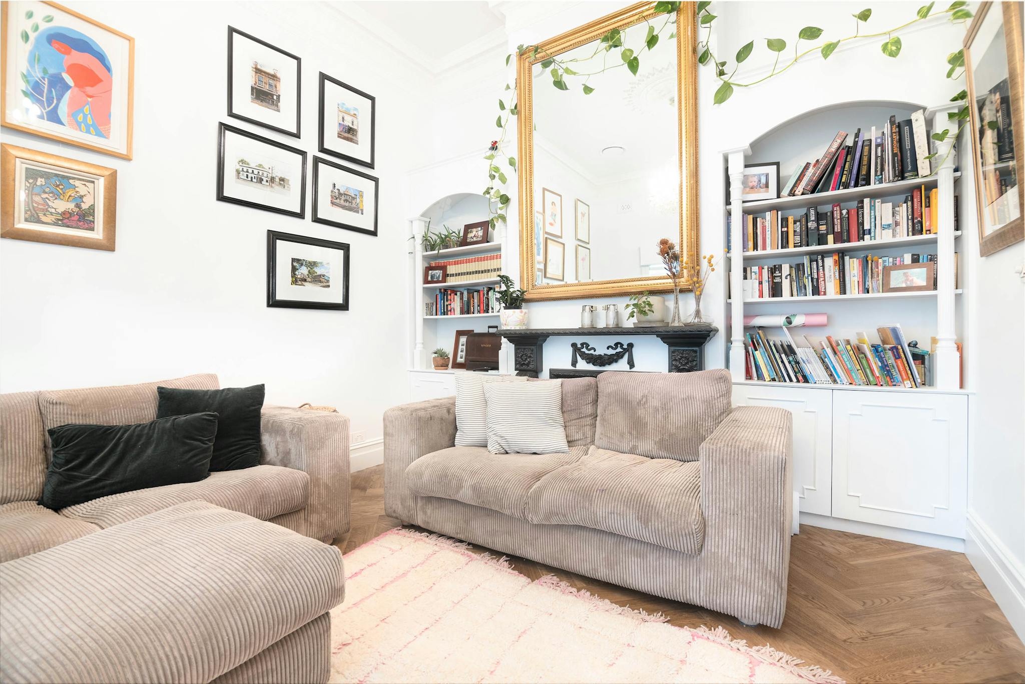 Bright living room with modern art, bookshelf, and comfortable sofa in Melbourne home.